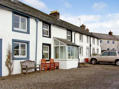 a group of white houses with a car parked outside at 2 Mellfell View in Penrith