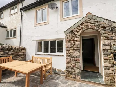 a table and benches outside of a house at Two Town End in Penrith