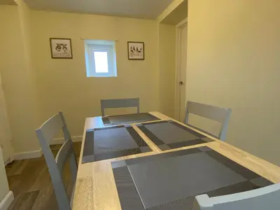 a dining room with a wooden table and chairs at Rattlebeck Farm Cottage and Hot Tub PET FRIENDLY in Welton