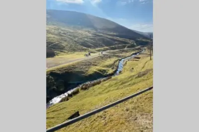 a river on the side of a hill at Glendyne Cottages, Highest Village in Scotland in Wanlockhead