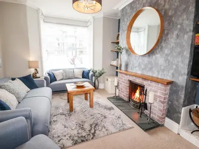 a living room with a couch and a fireplace at Stanegarth in Keswick