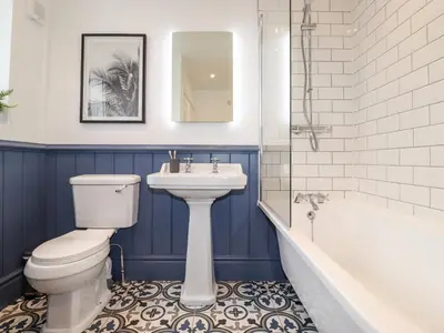 a bathroom with a toilet and a sink and a tub at Stanegarth in Keswick