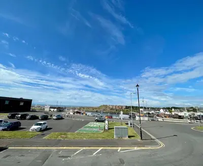 a parking lot with cars parked in a parking lot at Number 53 in Girvan