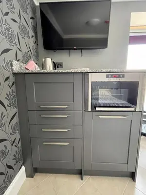 a kitchen with a counter with a stove top oven at Number 53 in Girvan