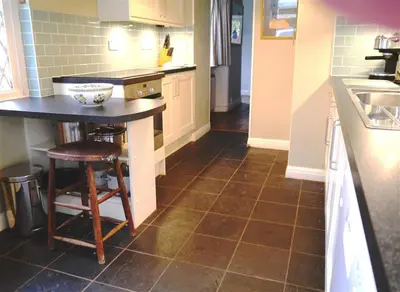 a kitchen with a counter and a table in it at Bar Hill Lodge in Gatehouse of Fleet