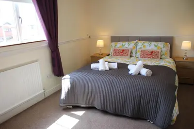 a bedroom with a bed with stuffed animals on it at Carvetii - Uriah House - 4-Bedroom House sleeps up to 10 people in Belle Vue