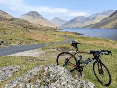 a bike parked on a hill next to a lake at Wayside Cottage 1637 in Millom