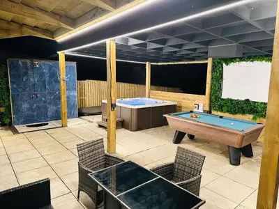 a patio with a pool table and a tub at Nether Newton - Sleeps 12, Hottub, Sauna, Private Garden in Newmilns