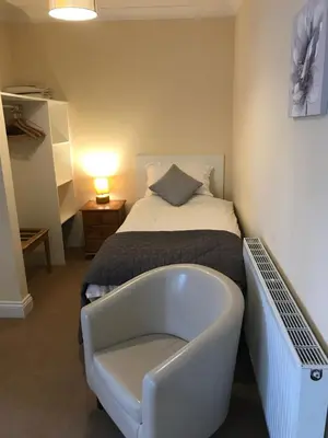 a bedroom with a bed and a bath tub at The Maxwell Arms Hotel in Dalbeattie