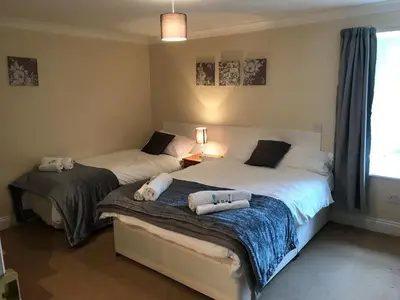 a bedroom with two beds with towels on them at The Maxwell Arms Hotel in Dalbeattie