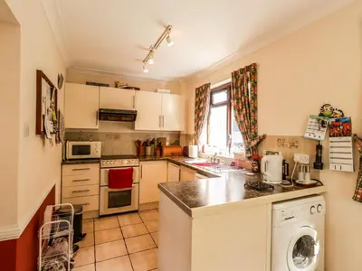 a small kitchen with a sink and a dishwasher at Wood End in Dalbeattie