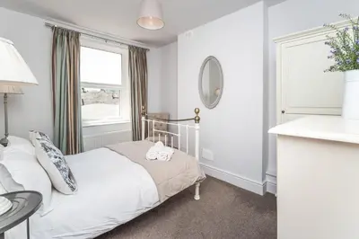 a small bedroom with a bed and a window at 9 The Townhouse in Keswick