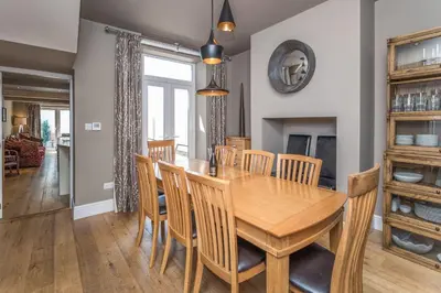 a dining room with a wooden table and chairs at 9 The Townhouse in Keswick