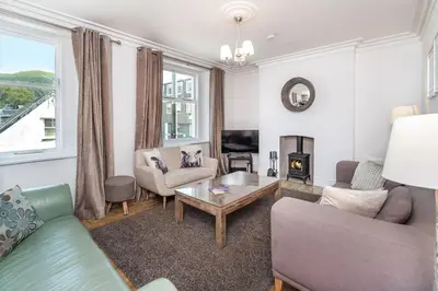 a living room with a couch and a table at 7 The Townhouse in Keswick
