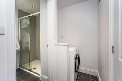 a bathroom with a shower and a glass shower door at 7 The Townhouse in Keswick