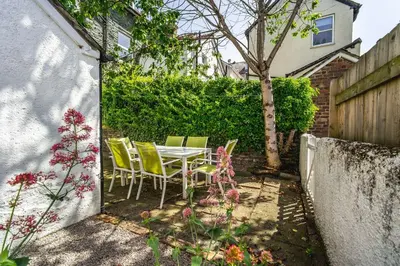 a table and chairs in the backyard of a house at 7 The Townhouse in Keswick