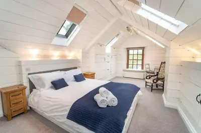 a bedroom with a bed with two towels on it at Barf Cottage in Portinscale
