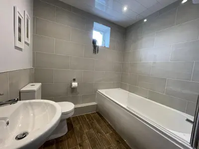 a bathroom with a tub and a toilet and a sink at Park View in Keswick