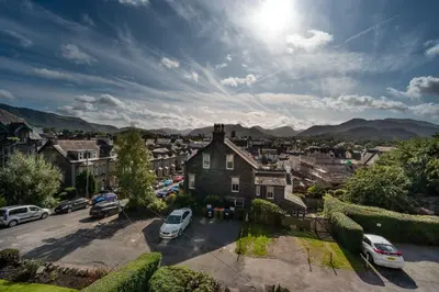 a city with cars parked in a parking lot at Skiddaw Skies in Keswick