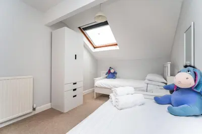 a bedroom with a blue stuffed animal sitting on the bed at Alban Rise in Keswick