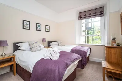 a bedroom with two beds and a window at The Ridgeway in Keswick