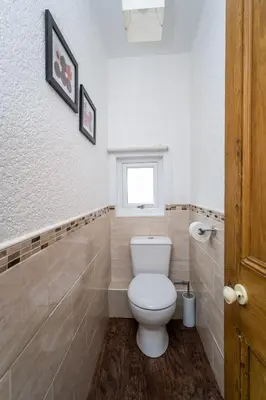 a bathroom with a toilet and a window at The Ridgeway in Keswick