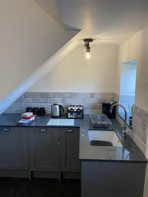 a kitchen with a sink and a counter top at Tawny Cottage in Portinscale