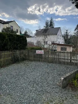 a sign on a fence in front of a house at Tawny Cottage in Portinscale