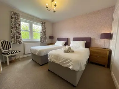 a hotel room with two beds and a window at Elm Cottage in Keswick