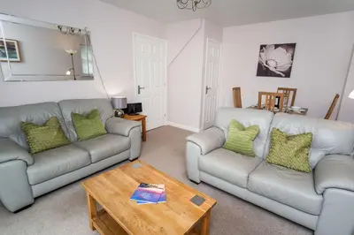 a living room with two couches and a coffee table at Elm Cottage in Keswick