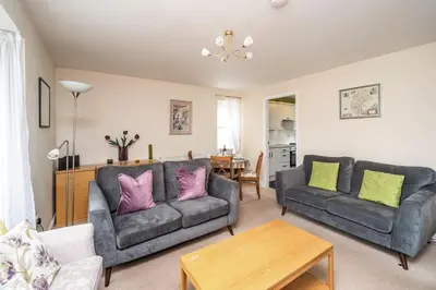 a living room with two couches and a table at Coledale in Keswick