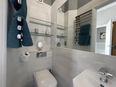 a bathroom with a white toilet and a sink at Bridge Cottage in Keswick