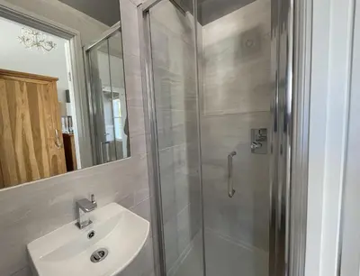 a bathroom with a sink and a shower at Bridge Cottage in Keswick
