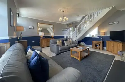 a living room with a couch and a table at Bridge Cottage in Keswick
