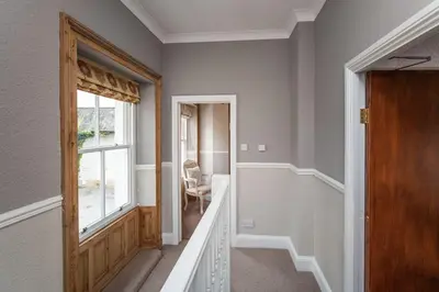 a hallway with a door and a window at Bridge Cottage in Keswick