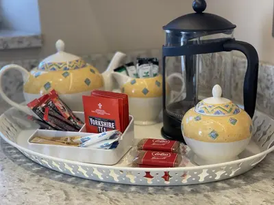 a tray with a tea kettle and tea packets at Bridge House in Keswick