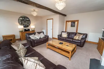 a living room with couches and a coffee table at Bridge House in Keswick
