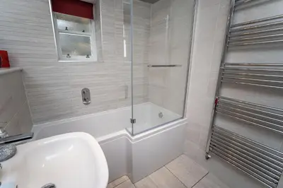a bathroom with a shower and a sink at Bridge House Apartment 1 in Keswick