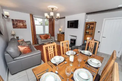 a living room with a table and a couch at Bridge House Apartment 1 in Keswick