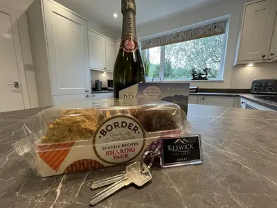 a bottle of champagne and a container of food on a counter at Causey View in Braithwaite