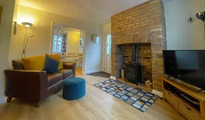 a living room with a couch and a fireplace at Byways in Keswick