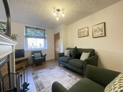 a living room with a couch and a fireplace at Birchgate in Keswick