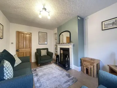 a living room with a couch and a fireplace at Birchgate in Keswick
