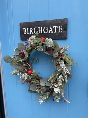 a christmas wreath on a blue door at Birchgate in Keswick
