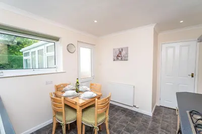 a dining room with a table and chairs and a window at Blencathra in Keswick