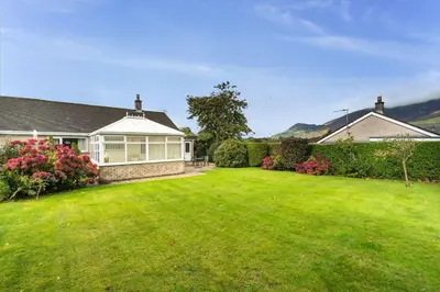 a house with a large yard with a large lawn at Blencathra in Keswick
