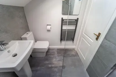 a bathroom with a toilet and a sink and a shower at Alison's View in Keswick