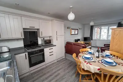 a kitchen and dining room with a table and chairs at Alison's View in Keswick