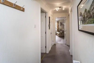 a hallway of a home with white walls and a hallway at Maiden Moor in Keswick