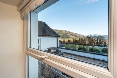 a window with a view of a balcony at Lake View Cottage in Braithwaite